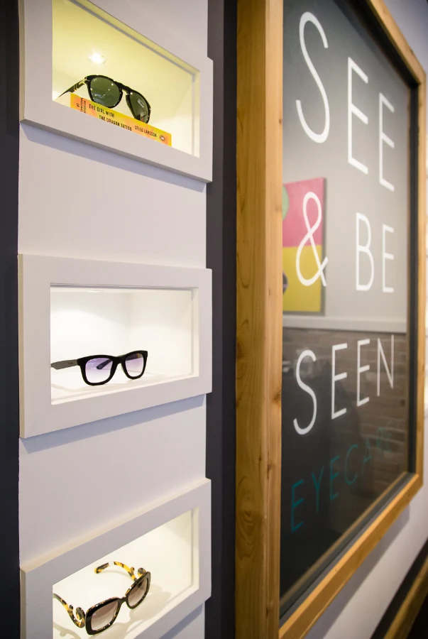 Illuminated display niches beside the clinic’s identity at See & Be Seen — Liberty Village