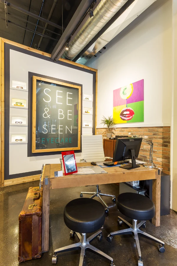 A consultation workstation beside the storefront at See & Be Seen — Liberty Village