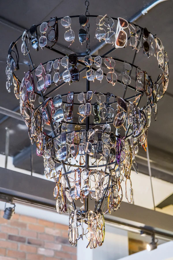 A chandelier assembled from eyeglass frames at See & Be Seen — Liberty Village