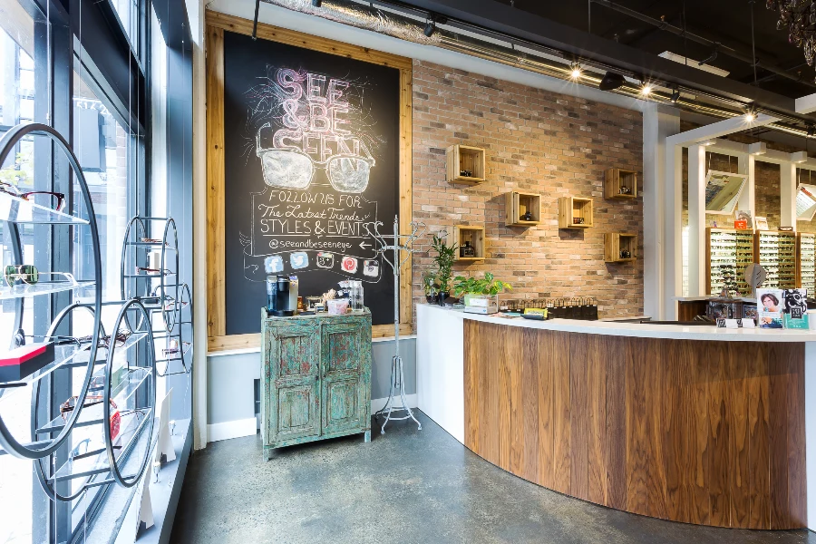Wood reception millwork against exposed brick at See & Be Seen — Liberty Village