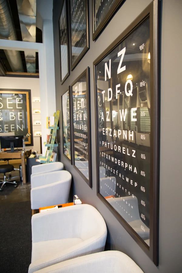Eye-chart graphics beside the waiting area at See & Be Seen — Liberty Village